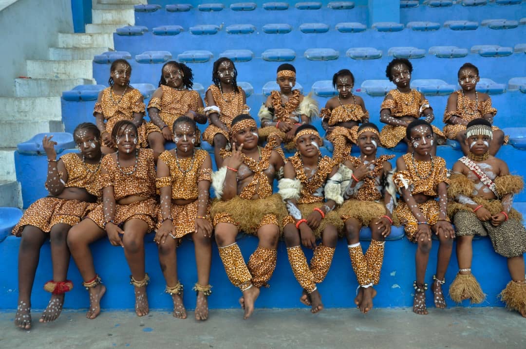 Students in cultural outfit sitting together